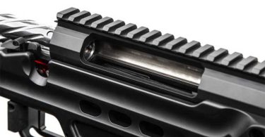 Close-up of an AR-15 upper receiver showing the ejection port and top rail