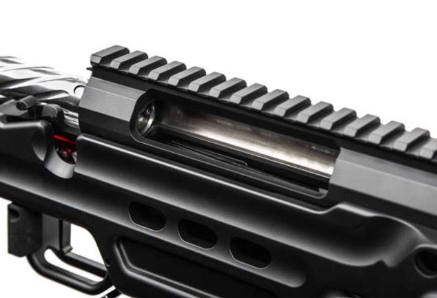 Close-up of an AR-15 upper receiver showing the ejection port and top rail