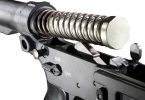 Close-up of an AR-15 lower receiver with buffer tube, buffer spring, and buffer partially removed
