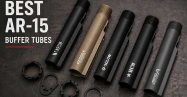 Several AR-15 buffer tubes and related components arranged on a dark workbench surface