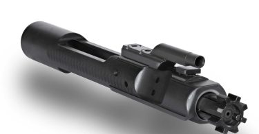 Close-up of an AR-15 bolt carrier group showing the gas key and bolt assembly on a white background
