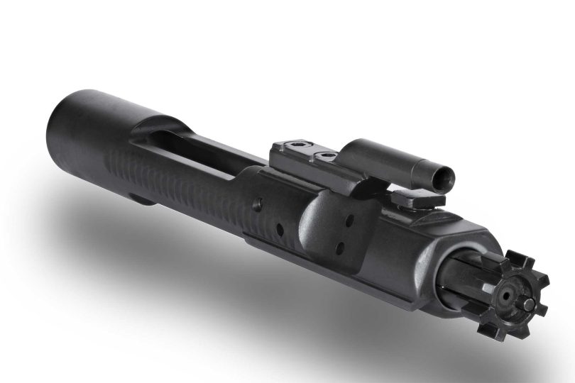 Close-up of an AR-15 bolt carrier group showing the gas key and bolt assembly on a white background