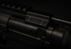 Close-up of an AR-15 bolt carrier group showing the gas key and mounting screws on top of the carrier