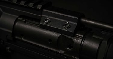 Close-up of an AR-15 bolt carrier group showing the gas key and mounting screws on top of the carrier
