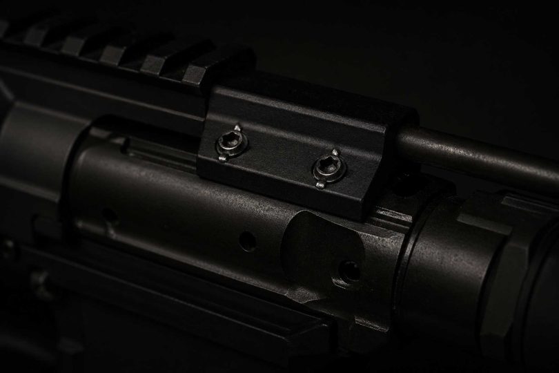 Close-up of an AR-15 bolt carrier group showing the gas key and mounting screws on top of the carrier