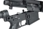Close-up of an AR-15 upper and lower receiver separated at the takedown pins