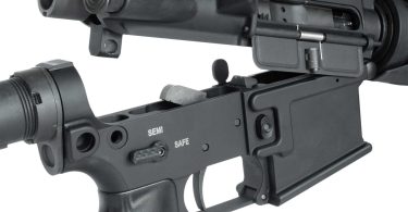 Close-up of an AR-15 upper and lower receiver separated at the takedown pins