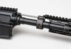Close-up of an AR-15 barrel with gas block and gas tube on a light background