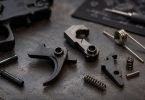 AR-15 fire control group components including trigger, hammer, disconnector, springs, and pins
