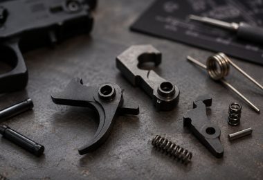 AR-15 fire control group components including trigger, hammer, disconnector, springs, and pins